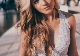 woman wearing lace halter top and blue denim jeans