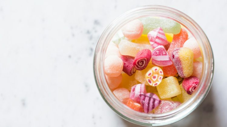 assorted-color candies on container