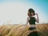 woman on wheat field during daytime