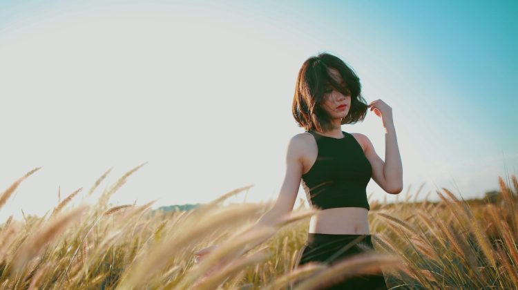 woman on wheat field during daytime